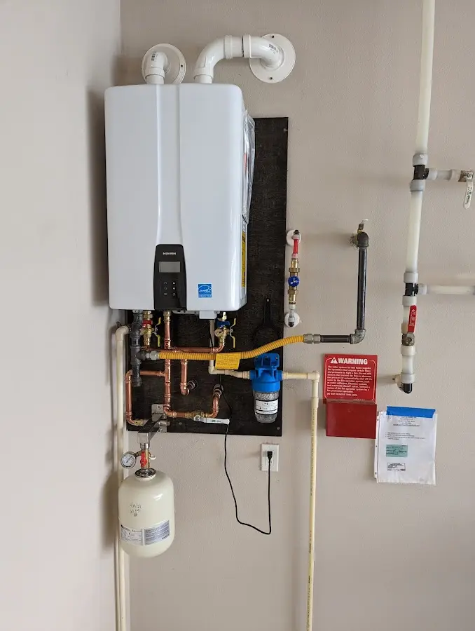 Professional plumber installing copper piping in a Independent Hill home